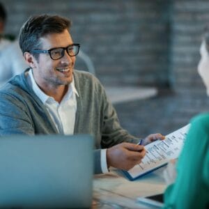 Business meeting with document discussion.